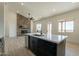 Modern kitchen with island, stainless steel appliances, and white cabinetry at 2383 E Cana Ln, Casa Grande, AZ 85194