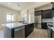 Modern kitchen with island, stainless steel appliances, and white cabinetry at 2383 E Cana Ln, Casa Grande, AZ 85194