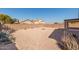 Desert landscape backyard with firepit and covered patio at 25360 W Fremont Ct, Buckeye, AZ 85326