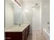 Clean bathroom with a bathtub, shower, and double vanity at 25360 W Fremont Ct, Buckeye, AZ 85326