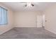 Bedroom with carpet flooring, ceiling fan and window with curtains at 25360 W Fremont Ct, Buckeye, AZ 85326