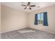 Bedroom with carpeted floor, ceiling fan and window with curtains at 25360 W Fremont Ct, Buckeye, AZ 85326