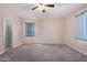 Bright bedroom with neutral walls, ceiling fan and carpet flooring at 25360 W Fremont Ct, Buckeye, AZ 85326