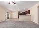 Open concept kitchen with dark wood cabinets and granite countertops at 25360 W Fremont Ct, Buckeye, AZ 85326