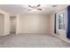 Large living room with neutral walls and carpet at 25360 W Fremont Ct, Buckeye, AZ 85326