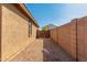 Gravel side yard with wooden gate and block wall at 25360 W Fremont Ct, Buckeye, AZ 85326