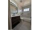 Bathroom with dark vanity, white countertop, and bathtub at 2611 N 40Th Ave, Phoenix, AZ 85009