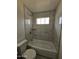 Bathroom with shower/tub combo and marble-look tile at 2611 N 40Th Ave, Phoenix, AZ 85009