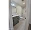 Modern bathroom with gray vanity, marble shower, and tile floor at 2611 N 40Th Ave, Phoenix, AZ 85009