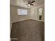 Spacious carpeted bedroom with ceiling fan and window blinds at 2611 N 40Th Ave, Phoenix, AZ 85009