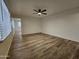 Living room with wood-look floors and updated ceiling fan at 2611 N 40Th Ave, Phoenix, AZ 85009