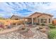 Landscaped backyard featuring a fire pit and seating area at 26236 W Wahalla Ln, Buckeye, AZ 85396