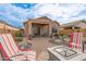 Relaxing backyard oasis with fire pit and patio furniture at 26236 W Wahalla Ln, Buckeye, AZ 85396