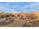 Landscaped backyard with fire pit and seating area at 26236 W Wahalla Ln, Buckeye, AZ 85396