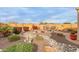 Landscaped backyard with a dry creek bed and desert plants at 26236 W Wahalla Ln, Buckeye, AZ 85396