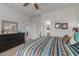 Bedroom with dresser, patterned bedding, and access to hallway bathroom at 26236 W Wahalla Ln, Buckeye, AZ 85396