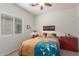 Bedroom featuring a red accent chest and a patterned comforter at 26236 W Wahalla Ln, Buckeye, AZ 85396