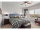 Bedroom with king-size bed, patterned bedding, and window coverings at 26236 W Wahalla Ln, Buckeye, AZ 85396