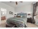 Bright bedroom with patterned bedding and ensuite bathroom access at 26236 W Wahalla Ln, Buckeye, AZ 85396