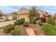 Single-story home with landscaped front yard, two-car garage, and desert landscaping at 26236 W Wahalla Ln, Buckeye, AZ 85396