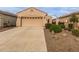 Attached garage with ample parking space and desert landscaping at 26236 W Wahalla Ln, Buckeye, AZ 85396