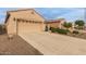 Two-car garage with driveway and neatly landscaped front yard at 26236 W Wahalla Ln, Buckeye, AZ 85396