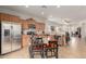 Kitchen with stainless steel appliances, wood cabinets, and breakfast bar at 26236 W Wahalla Ln, Buckeye, AZ 85396