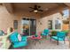 Relaxing covered patio with comfortable seating and a stone-paved floor at 26236 W Wahalla Ln, Buckeye, AZ 85396