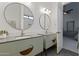 Bright bathroom featuring dual sink vanity and a large mirror at 2916 E Arrowhead Trl, Gilbert, AZ 85297