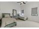 Bright bedroom featuring twin beds, a gray dresser, and plenty of natural light at 2916 E Arrowhead Trl, Gilbert, AZ 85297