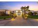 Elegant estate featuring double doors, desert landscaping, and pathway lighting at 2916 E Arrowhead Trl, Gilbert, AZ 85297