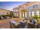 Charming outdoor living area featuring seating, a fireplace, and a decorative entrance at 2916 E Arrowhead Trl, Gilbert, AZ 85297