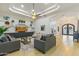 Elegant living room with tray ceiling, custom built-ins, and designer lighting at 2916 E Arrowhead Trl, Gilbert, AZ 85297