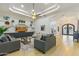 Inviting living room featuring a tray ceiling, hardwood floors, stylish furnishings, and open access to other living spaces at 2916 E Arrowhead Trl, Gilbert, AZ 85297