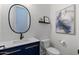 Stylish powder room with sleek fixtures, navy vanity, and modern artwork at 2916 E Arrowhead Trl, Gilbert, AZ 85297