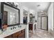 Bright bathroom with dual sinks, a large mirror, and a glass-enclosed shower at 3115 E Turnberry Dr, Gilbert, AZ 85298