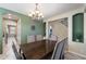 Elegant dining room featuring a chandelier, decorative walls, and views of the staircase at 3115 E Turnberry Dr, Gilbert, AZ 85298