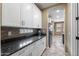 Galley kitchen featuring sleek countertops, ample cabinetry, and tile backsplash at 3115 E Turnberry Dr, Gilbert, AZ 85298