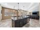 Stylish kitchen island with dark cabinetry, granite countertop, and pendant lighting at 3115 E Turnberry Dr, Gilbert, AZ 85298