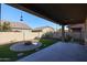 Covered patio area overlooking a fire pit and grassy backyard at 3134 E Sunrise Pl, Chandler, AZ 85286