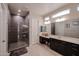 Modern bathroom with large shower, double vanity, and dark cabinets at 3134 E Sunrise Pl, Chandler, AZ 85286