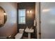 Stylish powder room with patterned wall and modern toilet at 3134 E Sunrise Pl, Chandler, AZ 85286