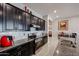 Sleek kitchen with dark cabinets, granite counters & island at 3134 E Sunrise Pl, Chandler, AZ 85286