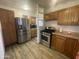 Kitchen boasts stainless steel appliances and wood cabinets at 3215 W Garfield St, Phoenix, AZ 85009