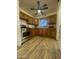 Kitchen with wood cabinets, stainless steel appliances, and laminate flooring at 3215 W Garfield St, Phoenix, AZ 85009