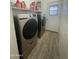 Laundry room with Samsung washer and dryer and built in shelving at 3215 W Garfield St, Phoenix, AZ 85009