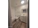 Bathroom with white vanity, bathtub, and wood-look floors at 3307 W Altadena Ave, Phoenix, AZ 85029