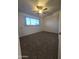 Bright bedroom with ceiling fan and large window at 3307 W Altadena Ave, Phoenix, AZ 85029