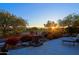 Landscaped backyard oasis with fountain and seating area at sunset at 33448 N 69Th Pl, Scottsdale, AZ 85266