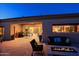 Covered patio with fire pit, seating and views into the home at 33448 N 69Th Pl, Scottsdale, AZ 85266